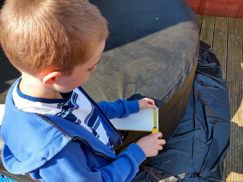 Oliver measuring a bit of wood