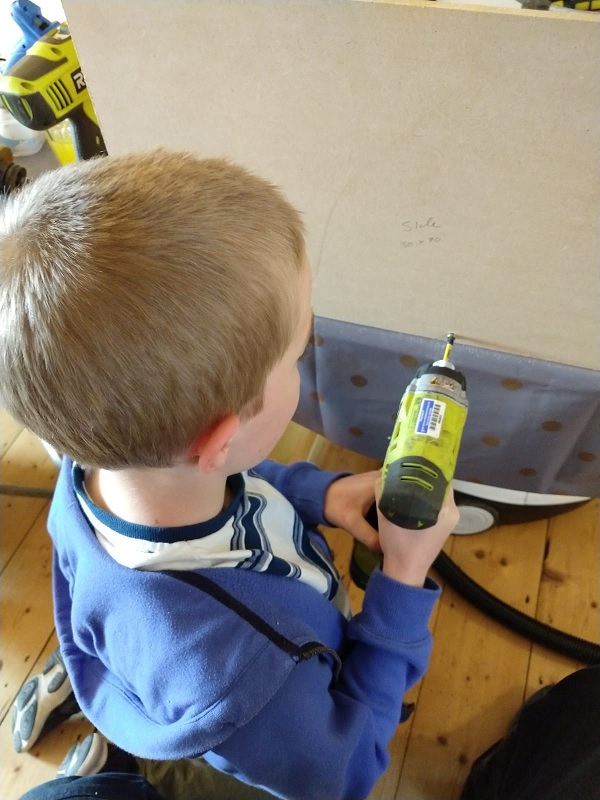 Oliver screwing a piece of wood