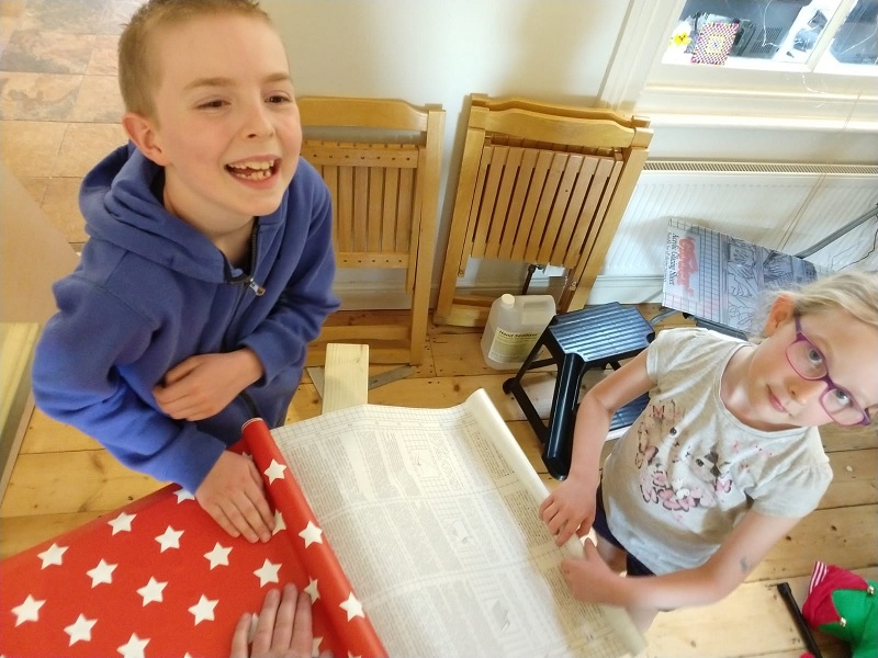 Oliver and Elizabeth sticking a sticker with stars