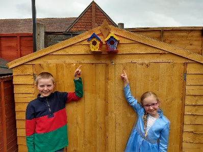 Oliver and Elizabeth next to their bird boxes